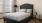 a bed with a black headboard